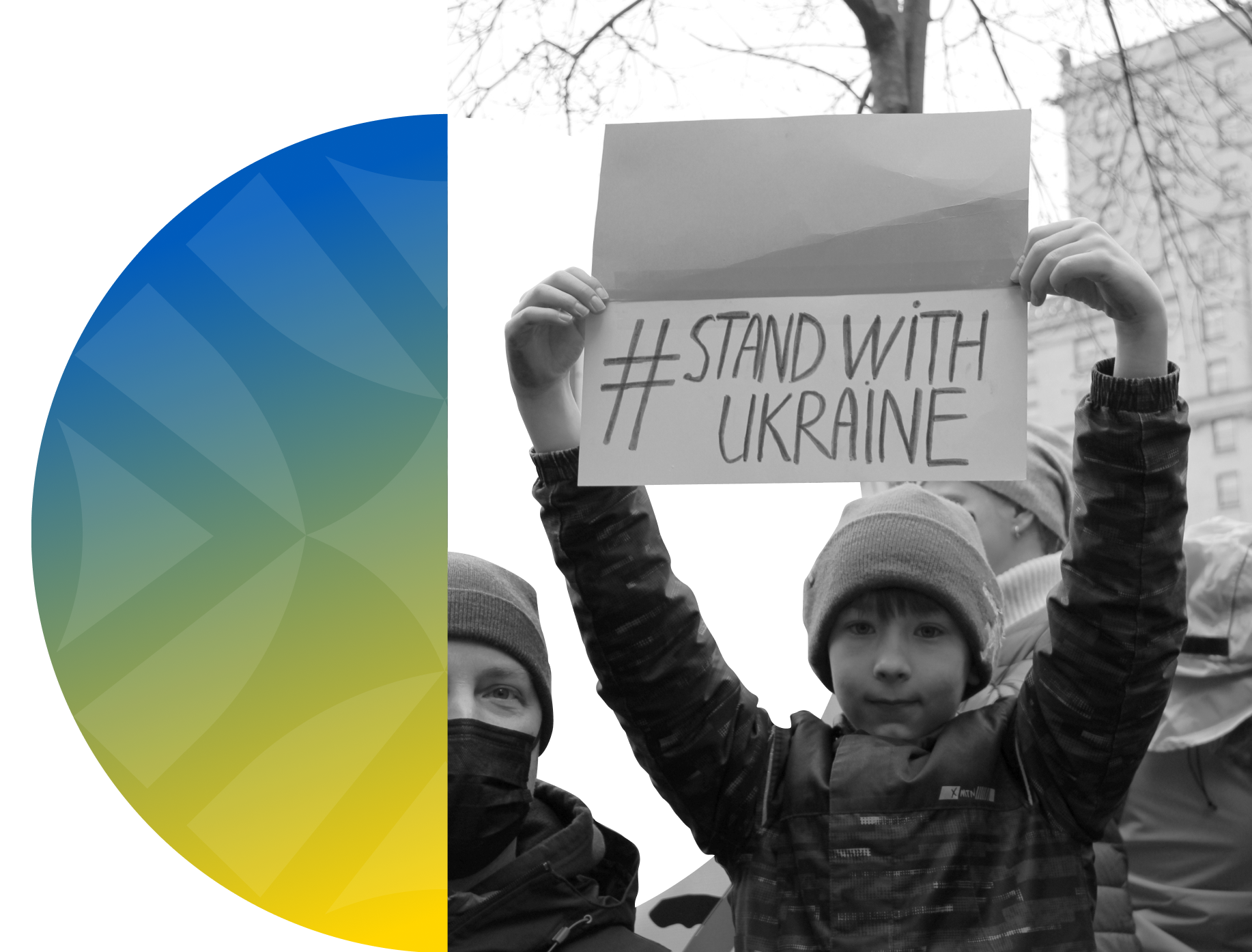 Boy holding a sign that says 'Stand with Ukraine.'