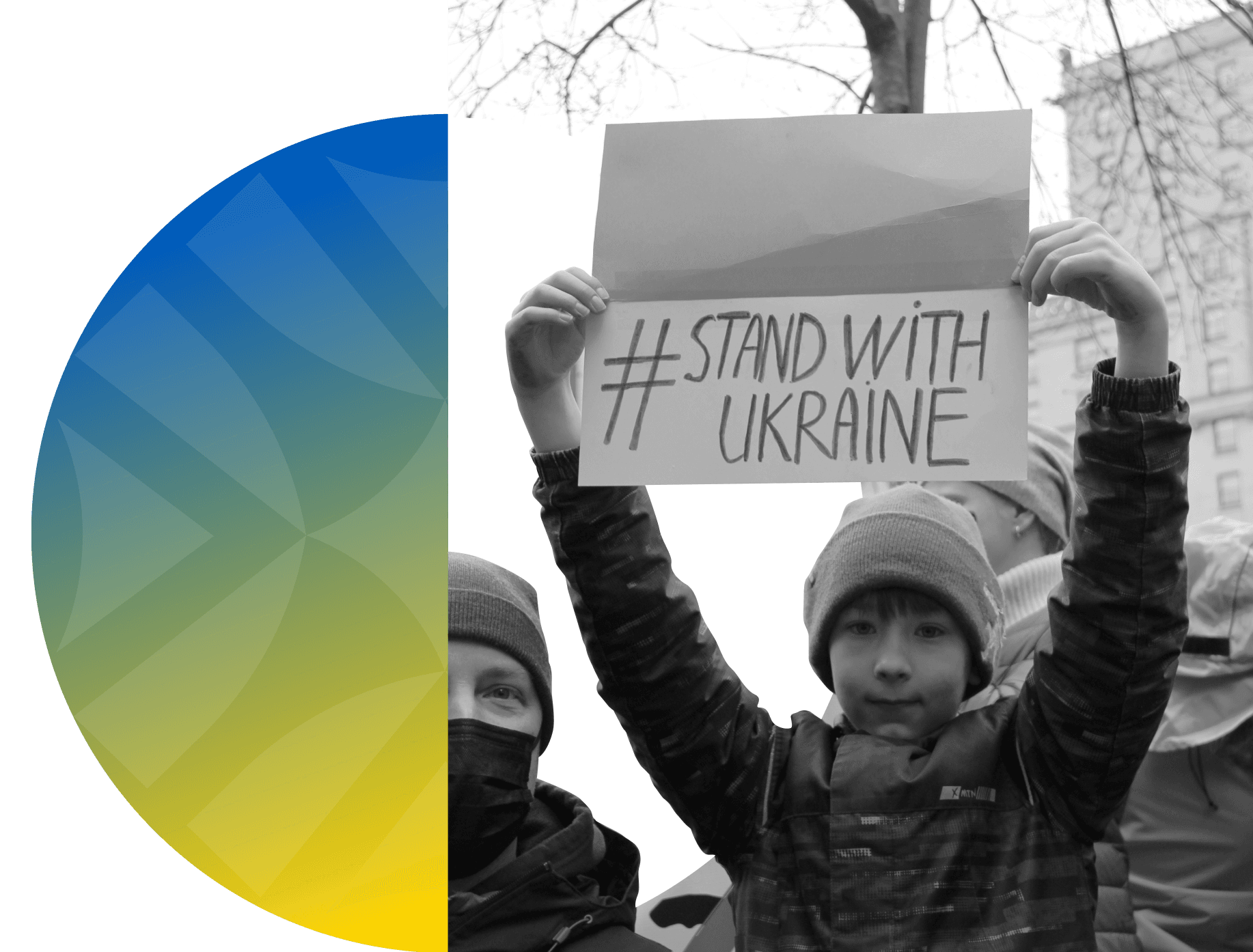 Boy holding a sign that says 'Stand with Ukraine.'