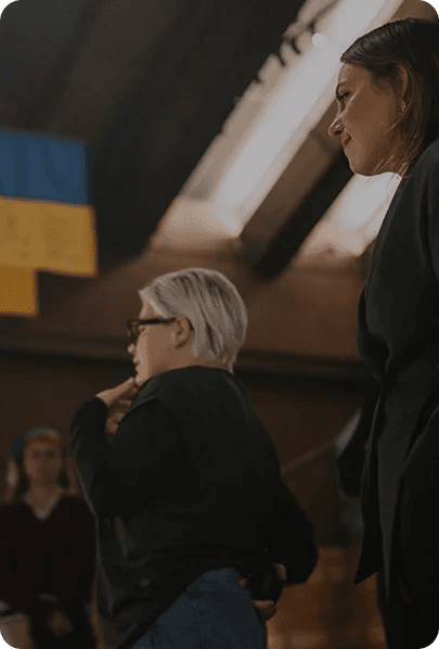 Profile of a woman in a community space with the Ukrainian flag