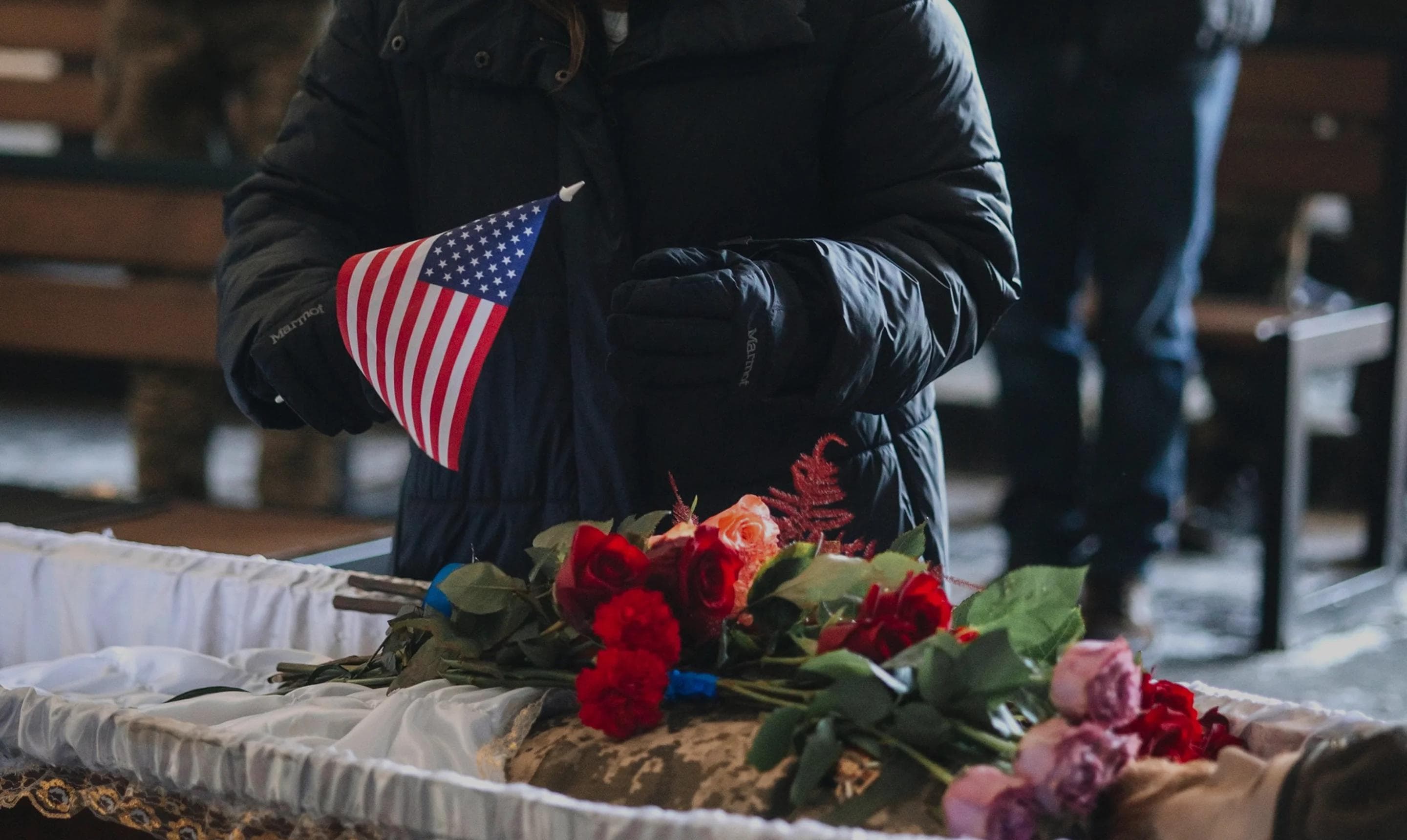 Person holding U.S. flag in tribute